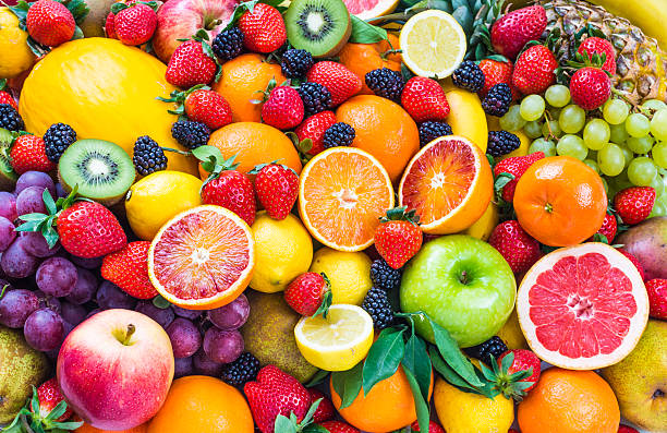 Fresh mixed fruits background.Organic fruits multicolore background.